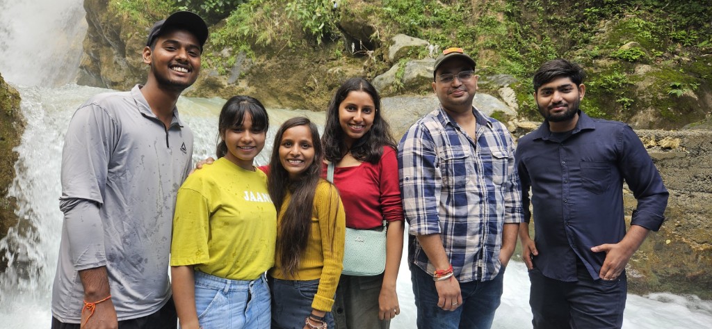 Team at a waterfall